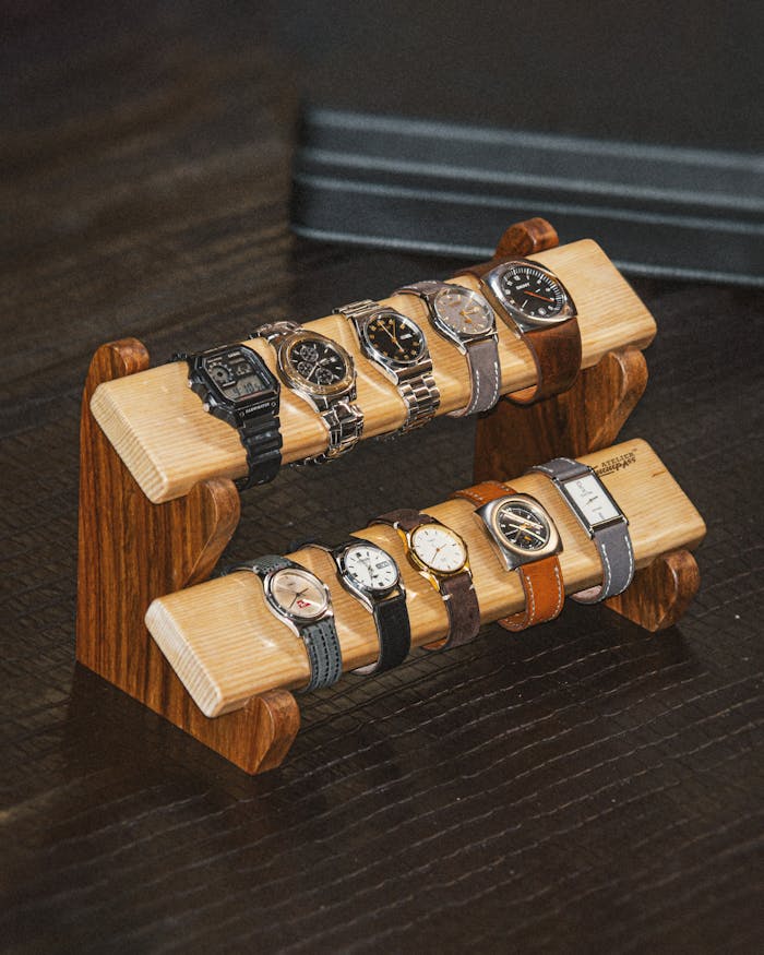 Rustic wooden stand elegantly displaying multiple luxury watches. Perfect for collectors and enthusiasts.