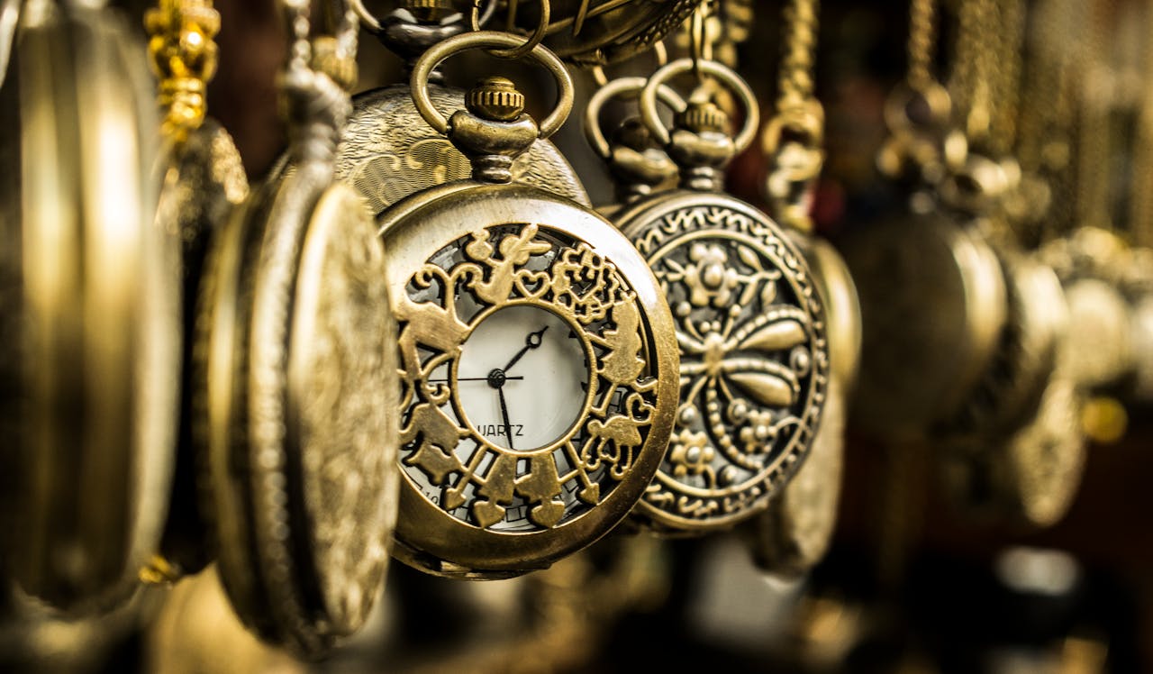 Close-up of ornate vintage pocket watches showcasing intricate designs and luxury aesthetics.